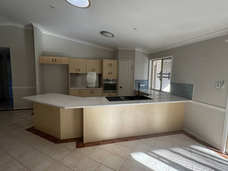 Original kitchen with a closed-in maple peninsula and tiled floor