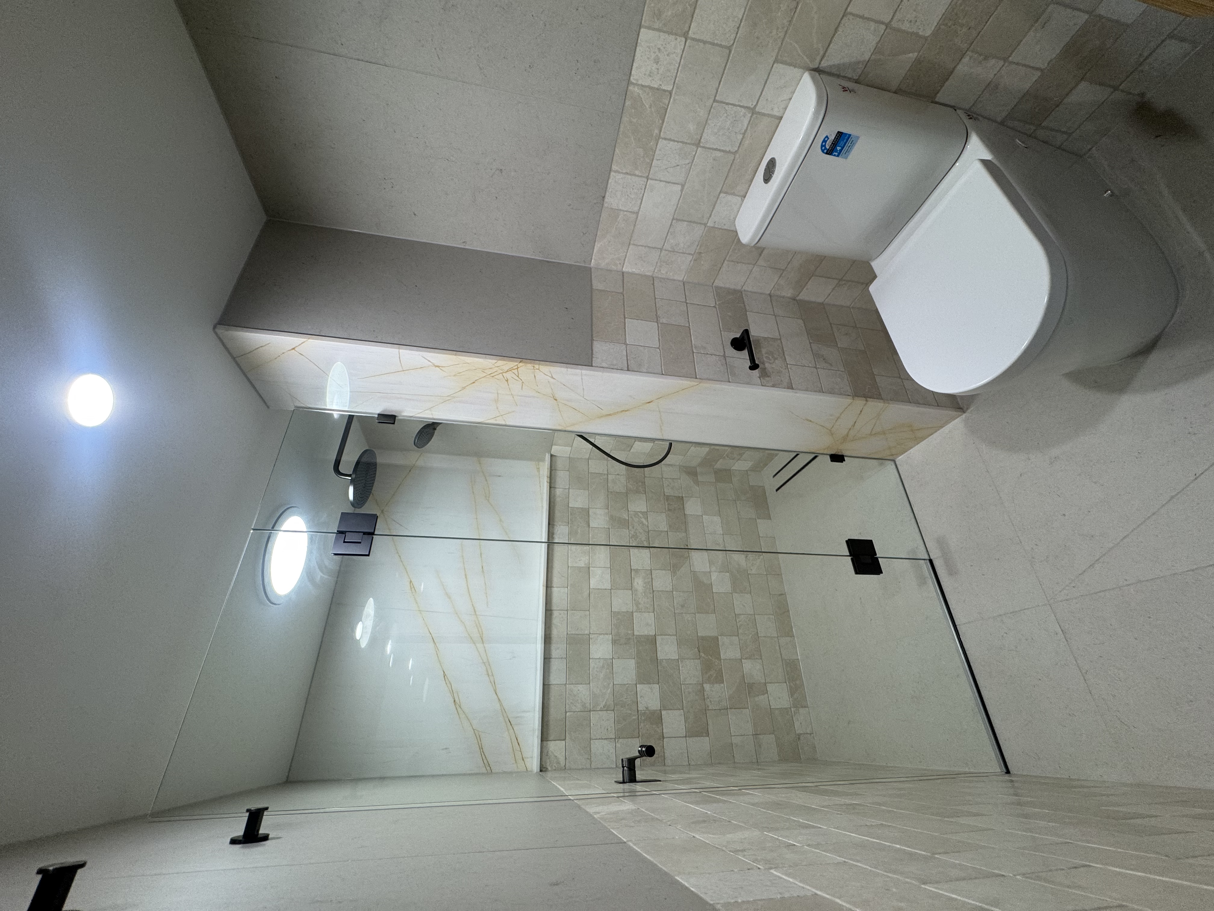 Walk-in shower with onyx and stone tile