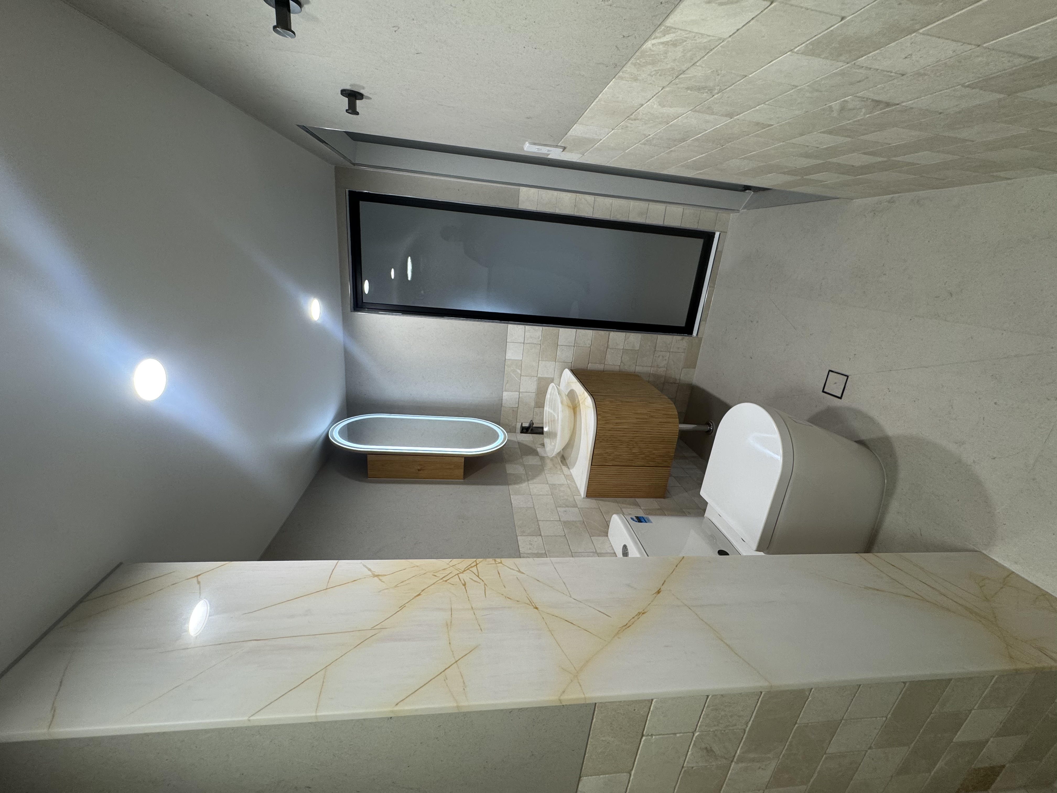 Freestanding tub with gold-veined onyx vanity