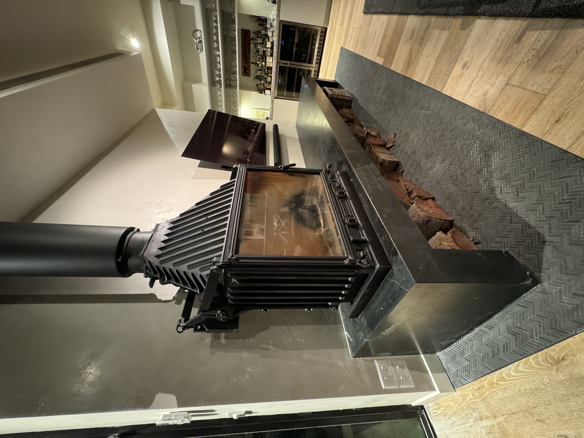 Cast-iron wood heater on black stone plinth