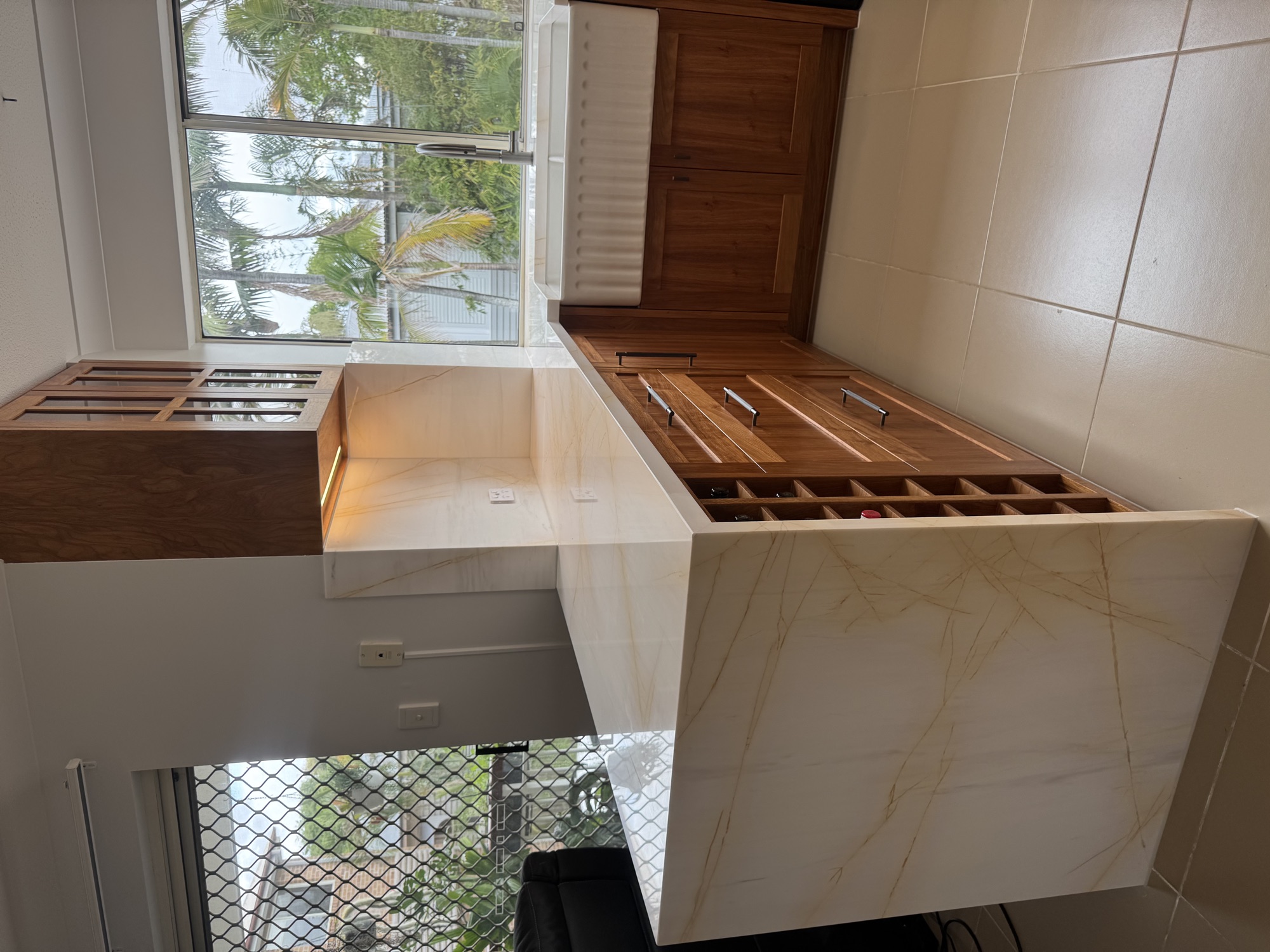 Walnut cabinetry and marble waterfall detail
