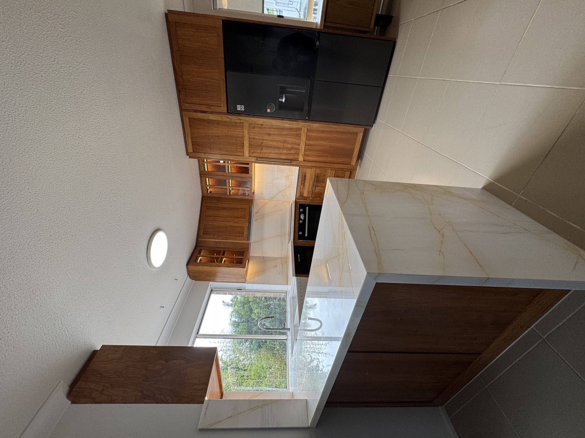 Walnut cabinetry with Calacatta marble waterfall benchtop