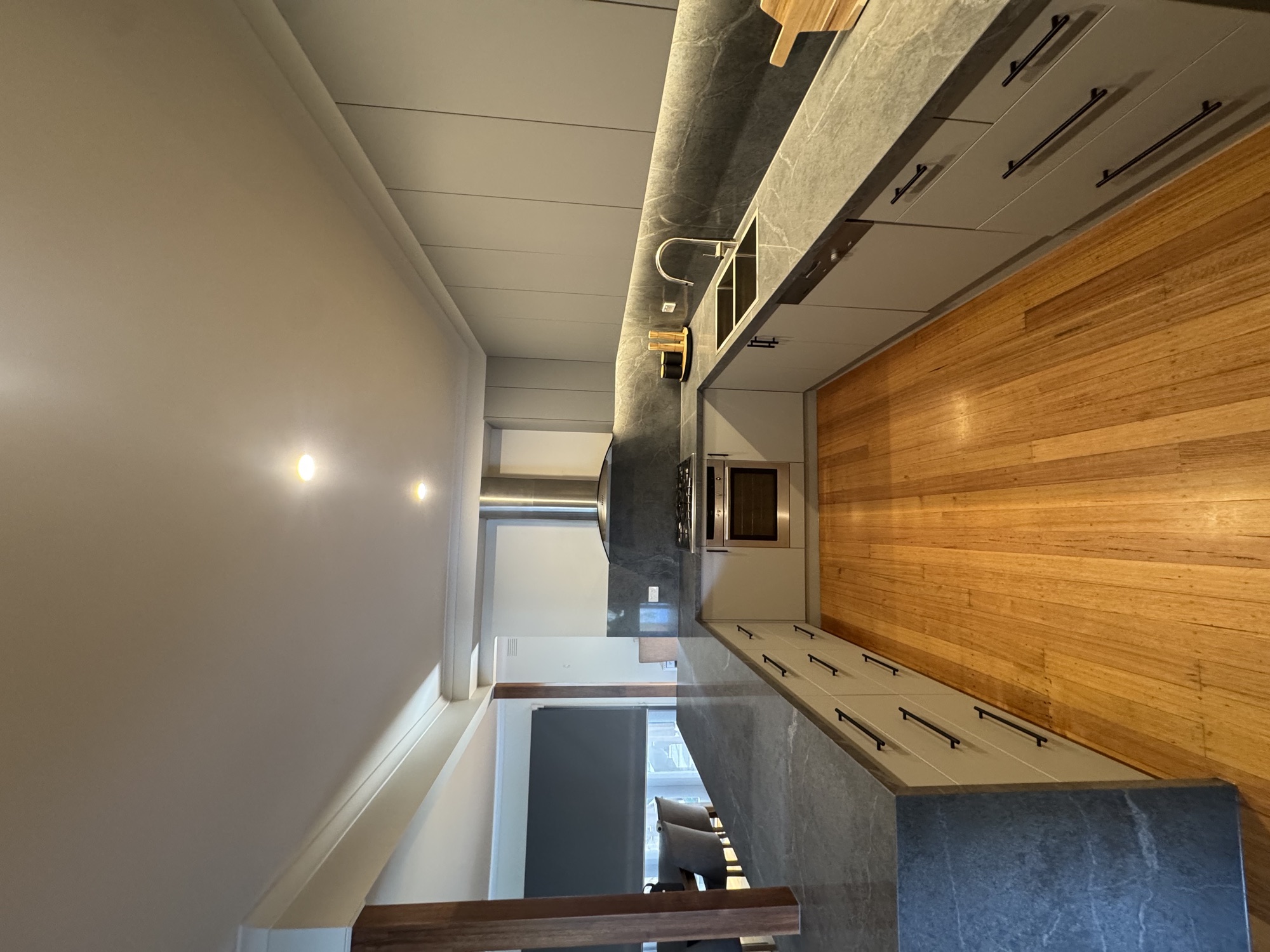 U-shape kitchen length view with stone benchtop